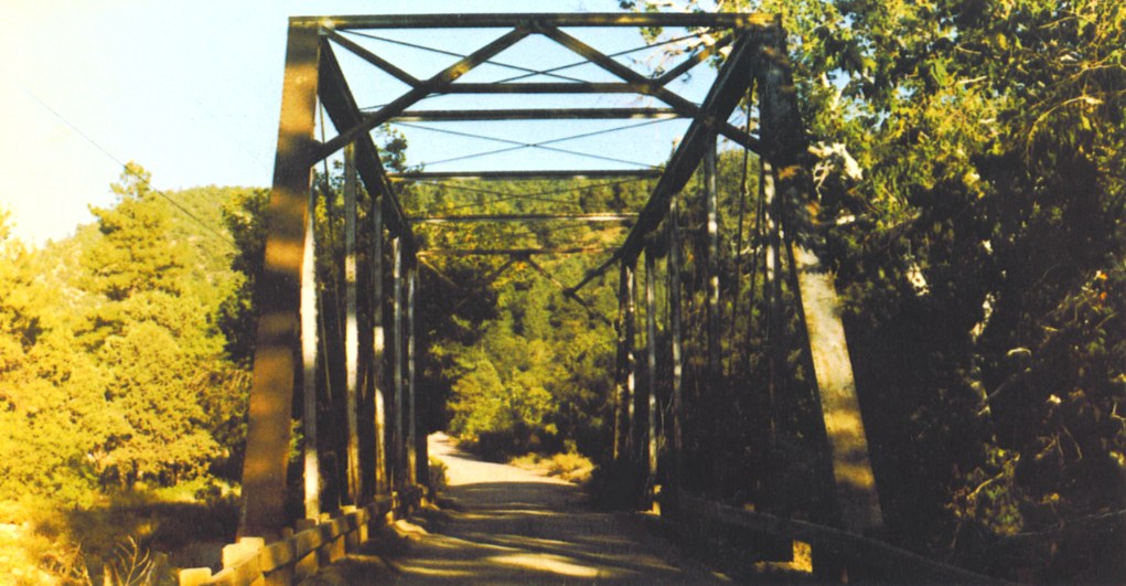 Forested mountain approach to the through-truss bridge in Young, Arizona